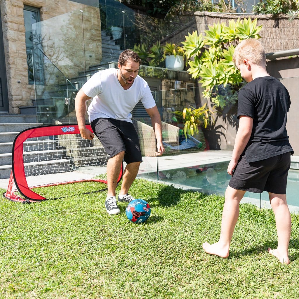 Father and Son in the backyard playing with the Wahu Pop Up Soccer Goals Set