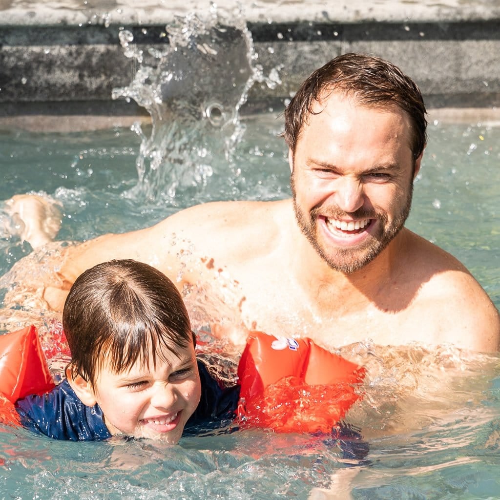 Family in pool child wearing Wahu Junior Armband Large