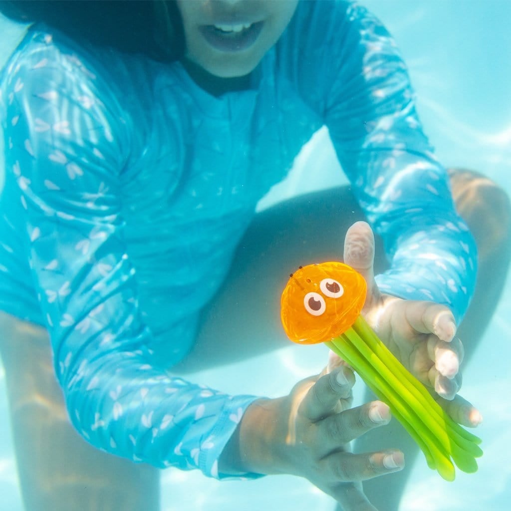 Child in pool playing with the Wahu Glow Gliders